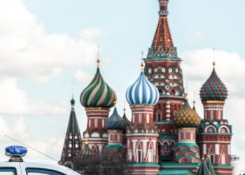 people walking on street near brown and green concrete building during daytime