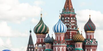people walking on street near brown and green concrete building during daytime
