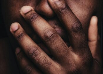 persons hand on his face