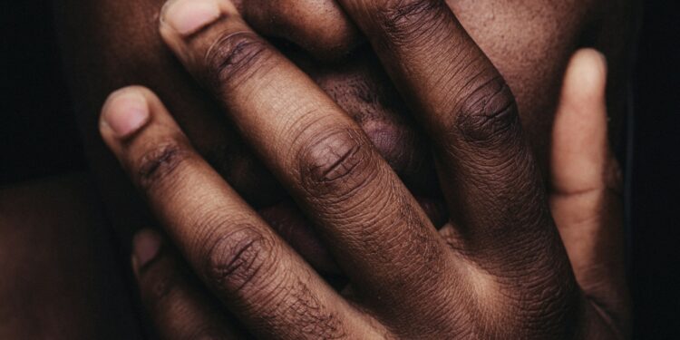 persons hand on his face