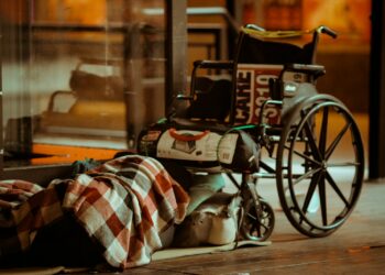 black and white leather bag on brown wooden table
