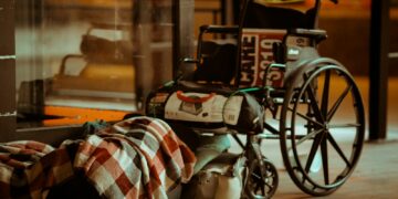 black and white leather bag on brown wooden table