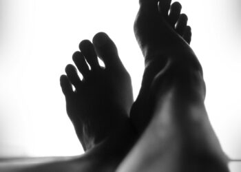 silhouette of person's feet against white background