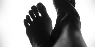 silhouette of person's feet against white background