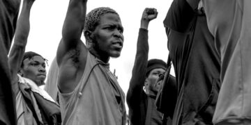grayscale photo of man in black long sleeve shirt