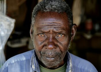 man wearing blue collared top