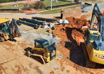 black and brown utility trailer on brown soil