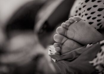 grayscale photo of baby's feet