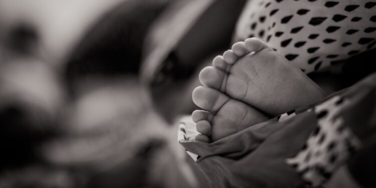 grayscale photo of baby's feet