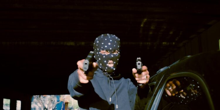 a person sitting on a car holding a camera