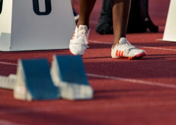 person standing beside white stand