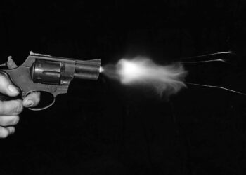 silver and black revolver on black surface