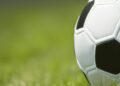 a white football ball on grass